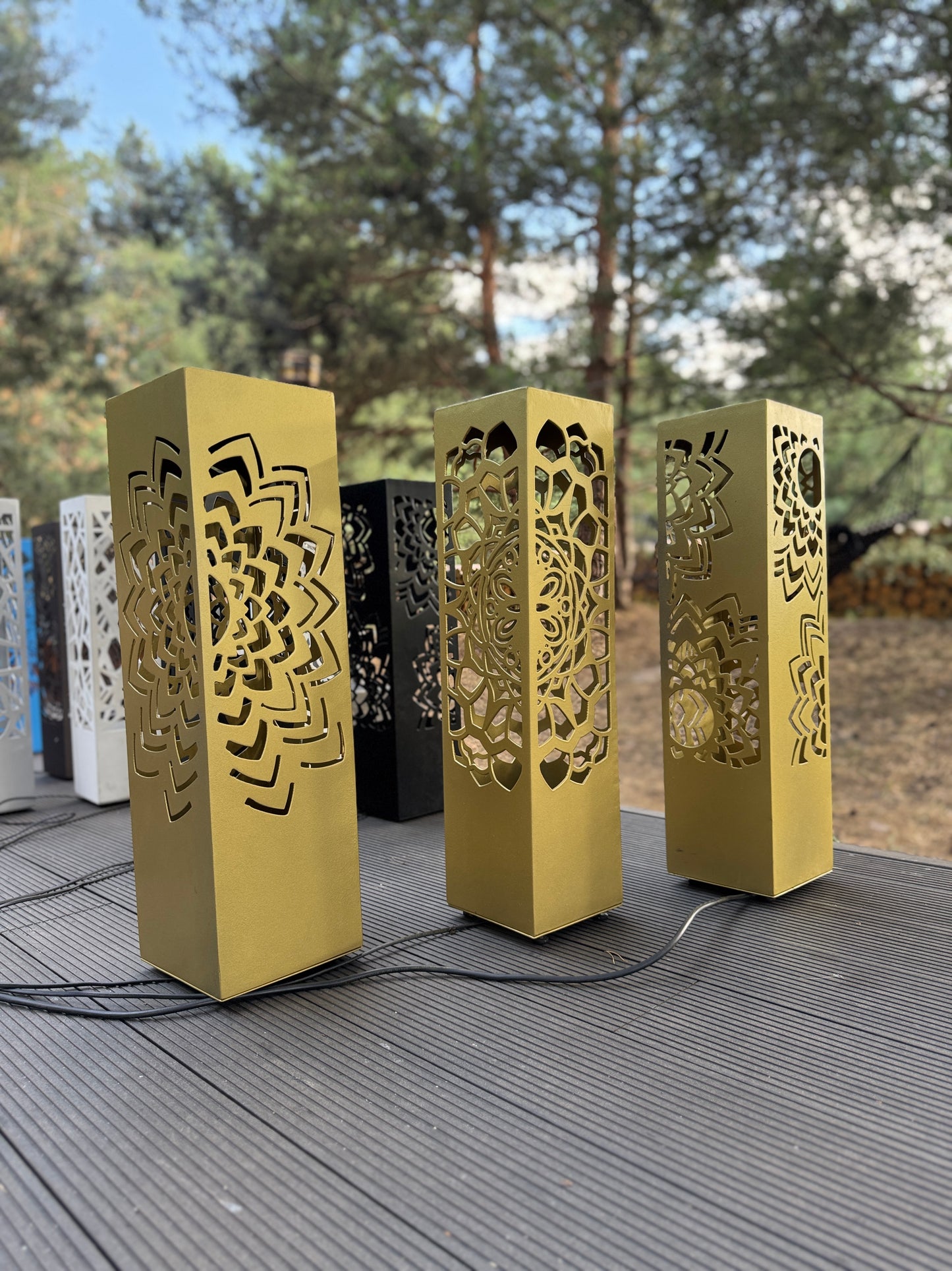 golden metal column lamp with LED lighting and decorative cutouts