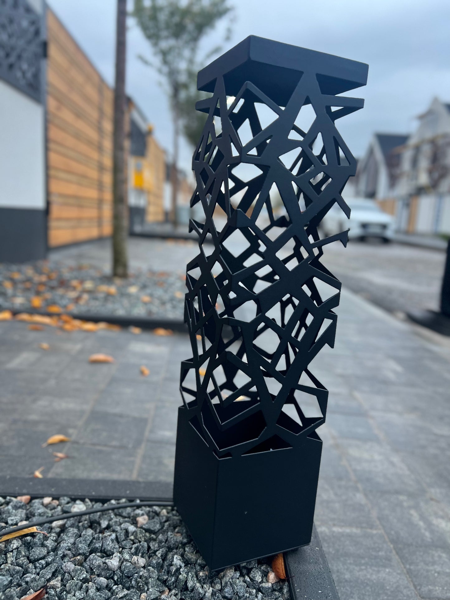 modern RGB LED floor lamp with artistic cut pattern standing outdoors
