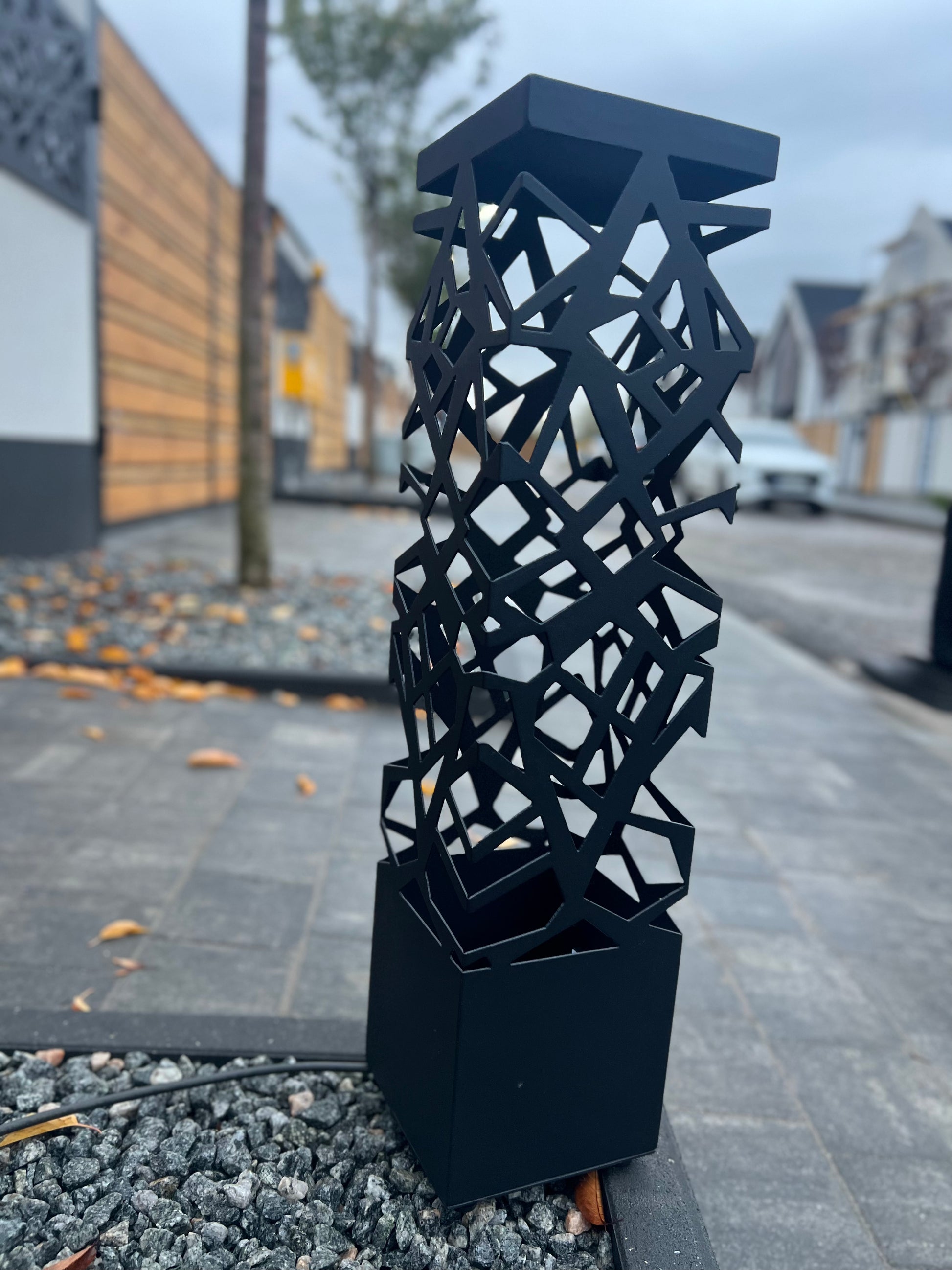modern RGB LED floor lamp with artistic cut pattern standing outdoors