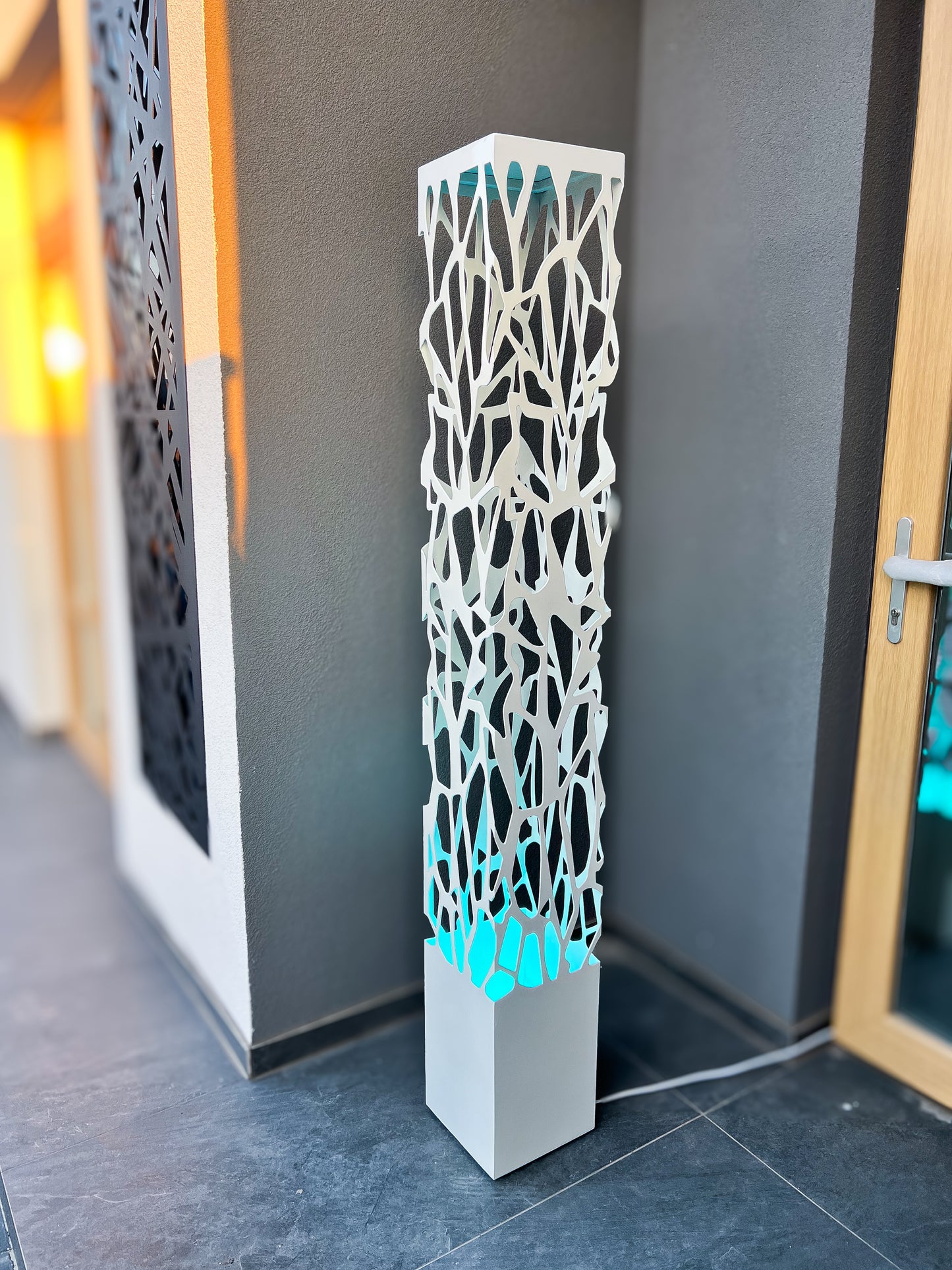 white metal outdoor column lamp with LED illumination and clean design